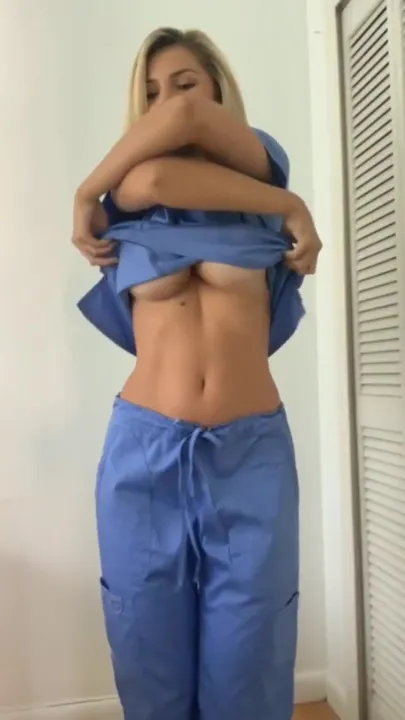 Sexy nurse stripping off her uniform