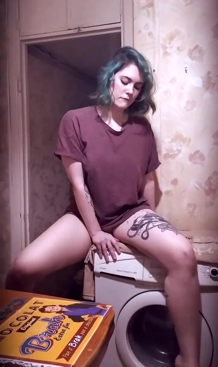 Tattooed teen plays with her trimmed pussy on the washing machine