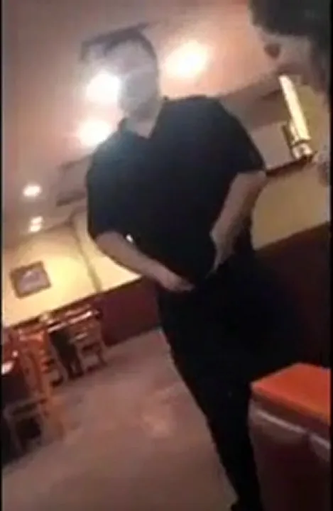 A waiter gets a blowjob inside of a restaurant