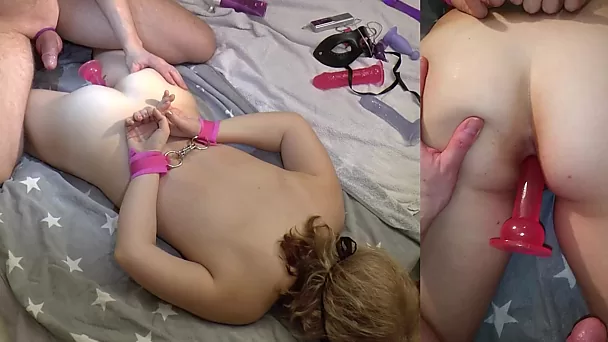 Amateur sex prone on the bed with handcuffs, toys and a fat cock