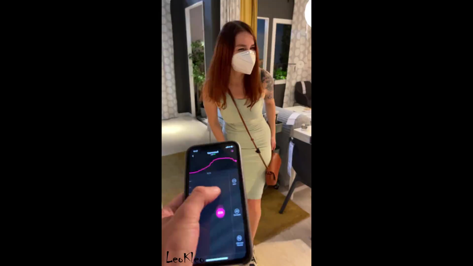 Guy presses the vibrator button while he and the girl are walking around the mall image