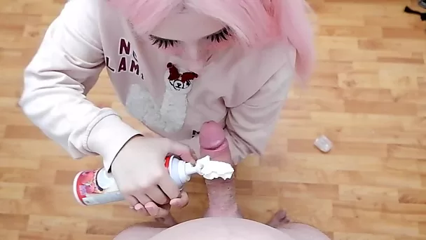 Pink hair minx sucking whipped cream off boyfriend's thick cock
