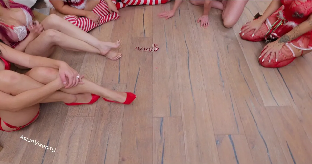 A group of girlfriends having holiday fun playing Spin the Bottle