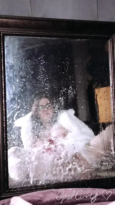 Naughty Ms. Claus power washing a mirror with pee