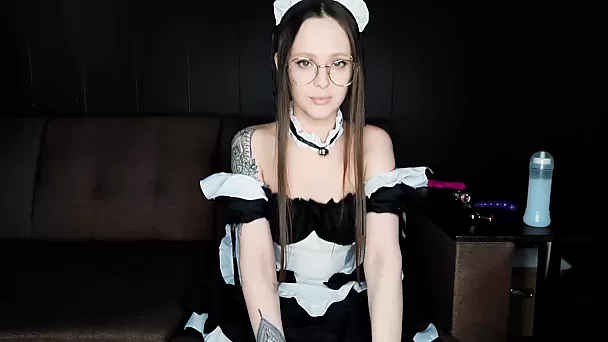 Maid in round glasses catches a long cumshot on her belly