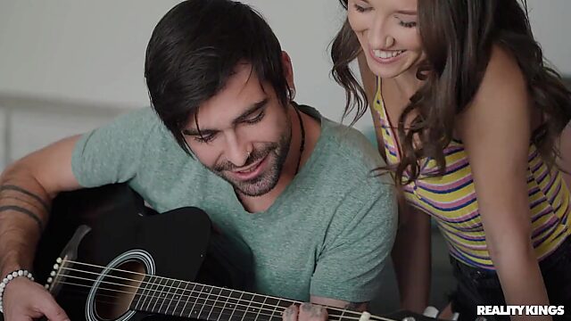 He plays the guitar and with her delicious pussy and small perky tits