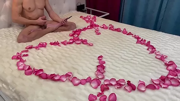 Young lad is waiting for his mature lady for romantic sex on a bed covered in rose petals