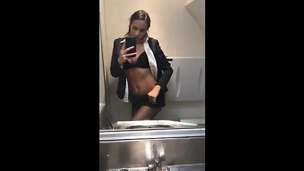 Incredible flight attendant posing nude in plane toilet and rubs her wet pussy