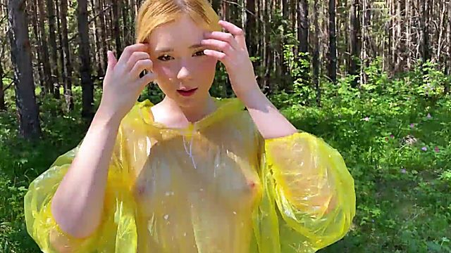 Young teen with big tits in raincoat sucks dick in forest and takes cum on her face