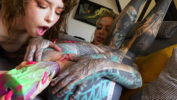 Bombasse bouclée sexy et sa meilleure amie tatouée bizarre s'enfoncent d'énormes jouets dans le cul et profitent d'un plan à trois sauvage