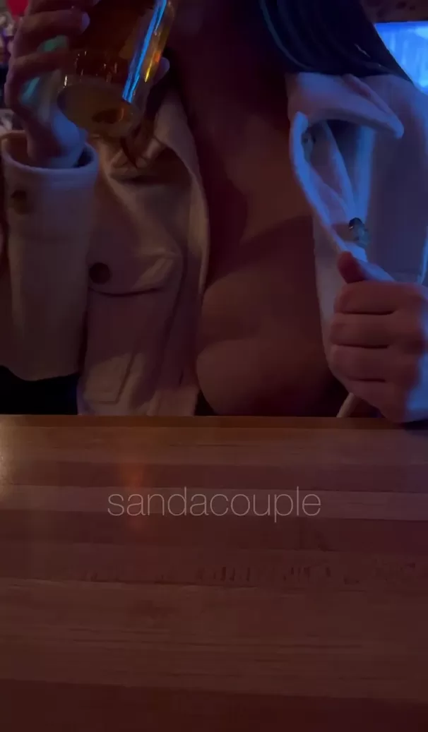 Having a drink while exposing my titty at the bar