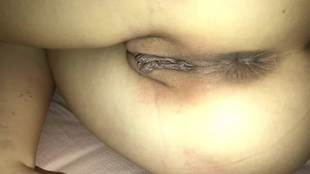 Sensually caressing the shaved pussy of a Latin bitch in close-up.