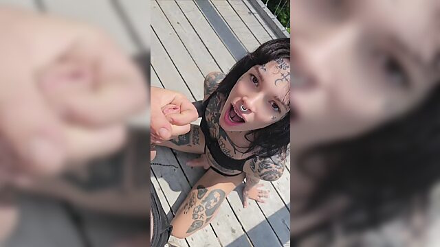 Tattooed tranny with a forked tongue does a public blowjob in the middle of the forest.