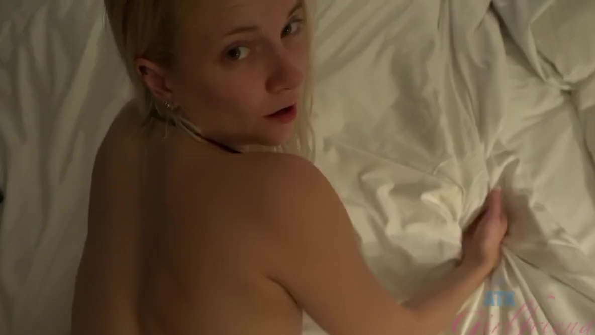 Petite blonde cutie with small tits lies on the bed and helps to relax