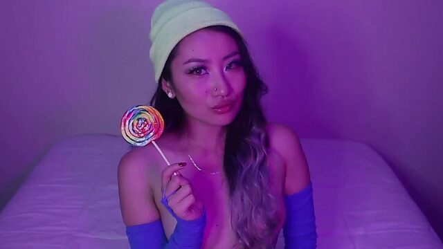 Asian webcam-slut shows her small boobs and licks lollipop