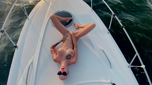 Busty bald babe fingers her twat in amazing solo on a yacht