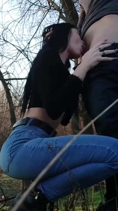 Brunette whore gives BJ to lucky guy in forest photo